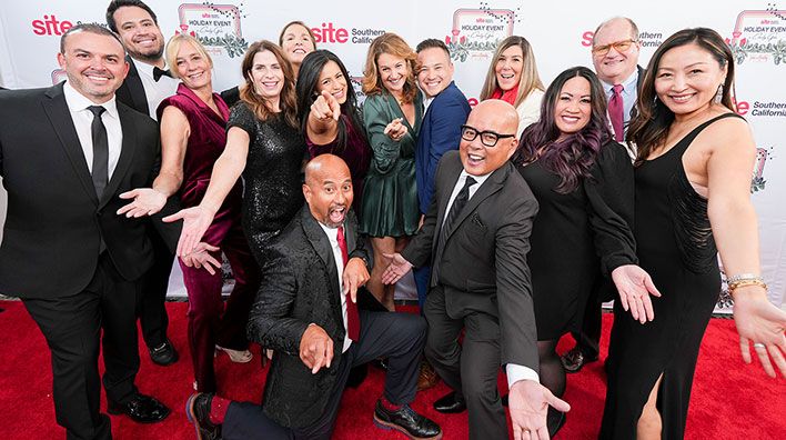 Group of people goofing off at the step and repeat