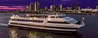 The Inspiration Hornblower cruising San Diego Harbor in the evening.